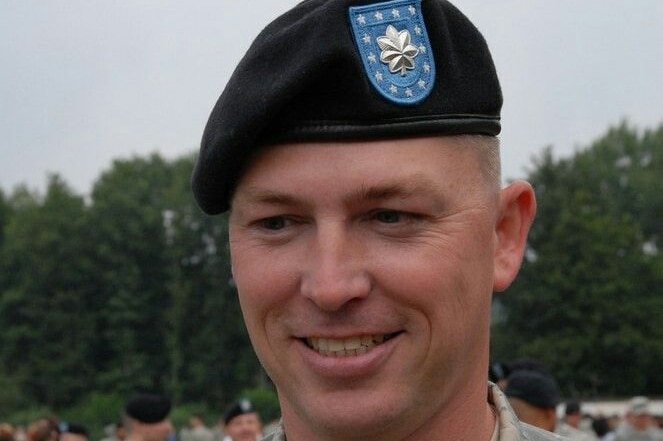 Bryan Denny wearing a military beret and uniform.