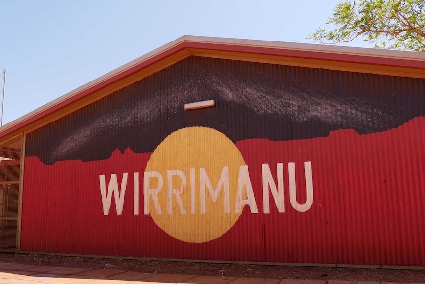 A large, barn-like building with an aboriginal flag and 'Wirrimanu' emblazoned on its corrugated cladding.