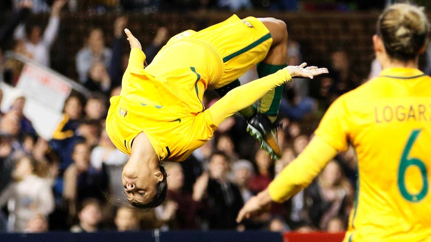 Sam Kerr does a backflip after scoring a goal.