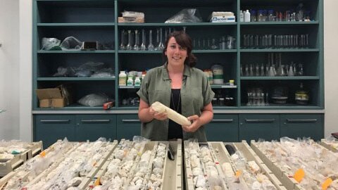 Marine geologist Dr Belinda Dechnik with a core sample from the Great Barrier Reef