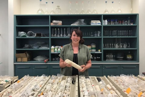Marine geologist Dr Belinda Dechnik with a core sample from the Great Barrier Reef