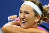 Victoria Azarenka grimaces as she holder her racquet in both hands behind her head