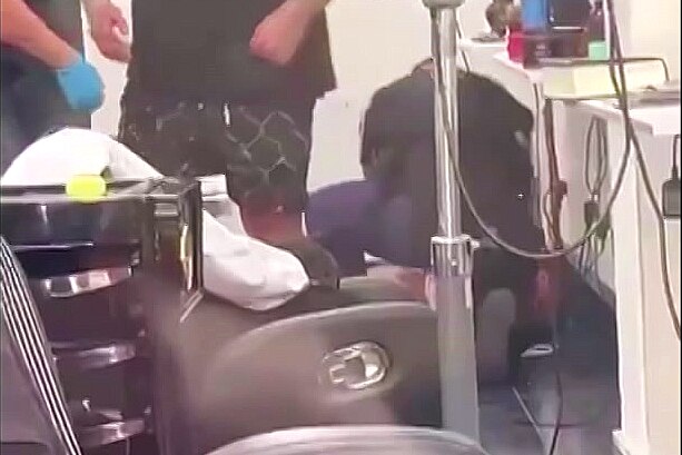 police inside a barbers hop after two men were shot
