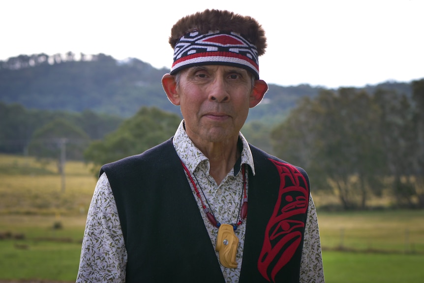 Portrait of man in traditional Haida dress looking at camera