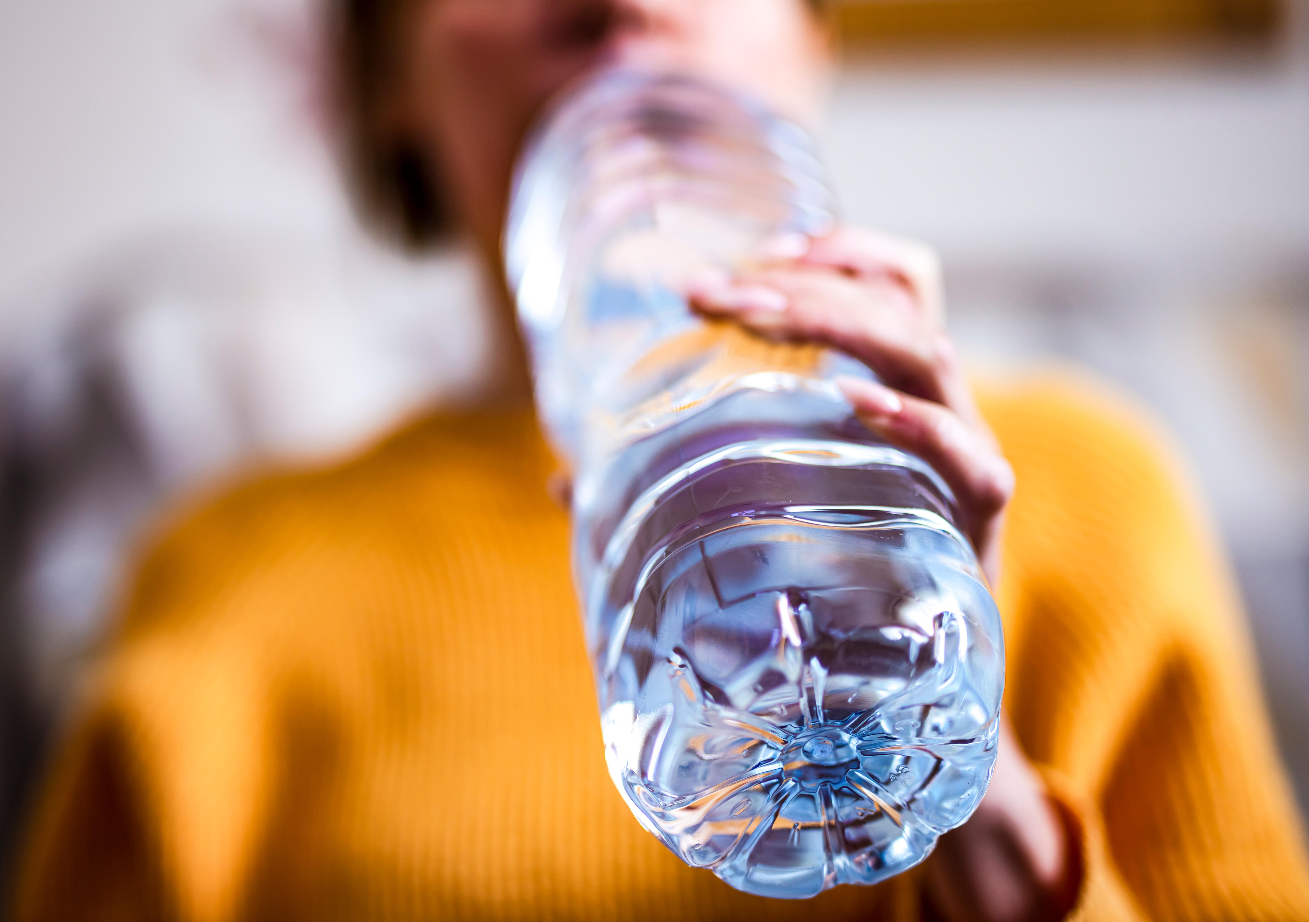 Woman drinking out of plastic bottle