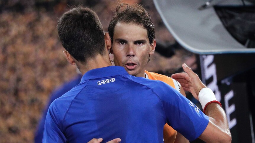 Rafael Nadal and Novak Djokovic hug each other after their Australian Open final.