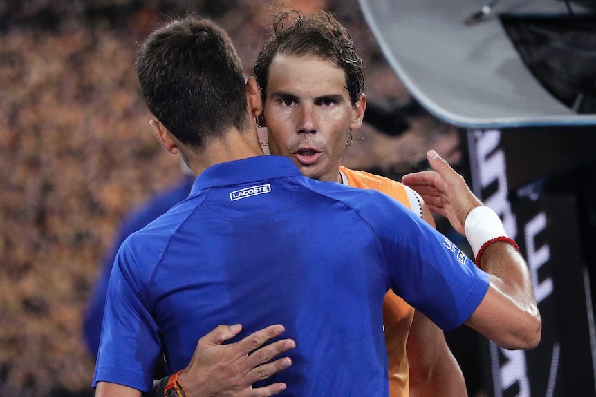 Rafael Nadal and Novak Djokovic hug each other after their Australian Open final.