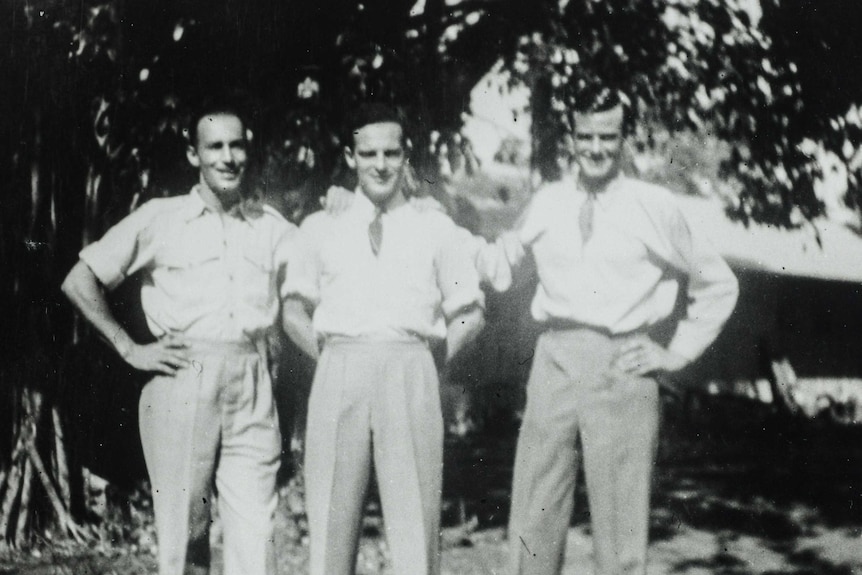 A black and white photo of three men in shirts and ties.