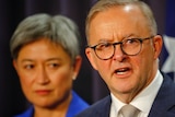 Anthony Albanese speaks while standing in front of Penny Wong