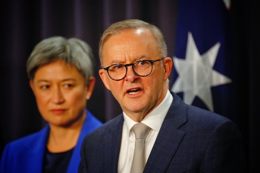 Anthony Albanese speaks while standing in front of Penny Wong