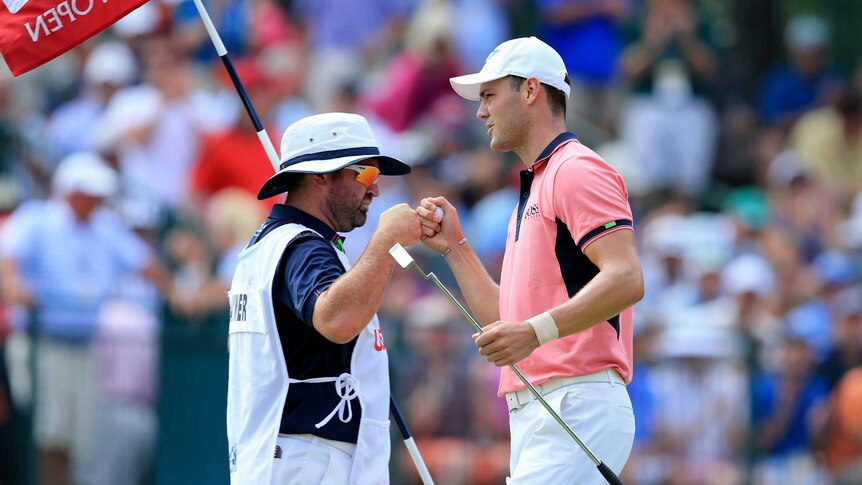 Martin Kaymer (R) celebrates an eagle with caddie Craig Connelly during the US Open third round.