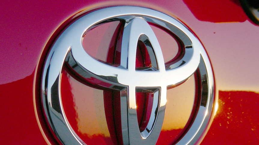 The Toyota logo on a red car.