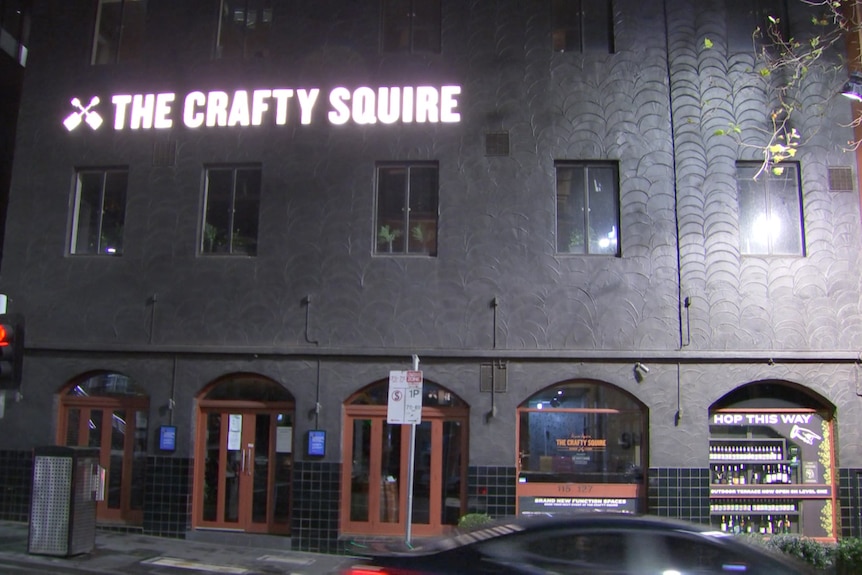 The Crafty Squire sign outside the pub at night.