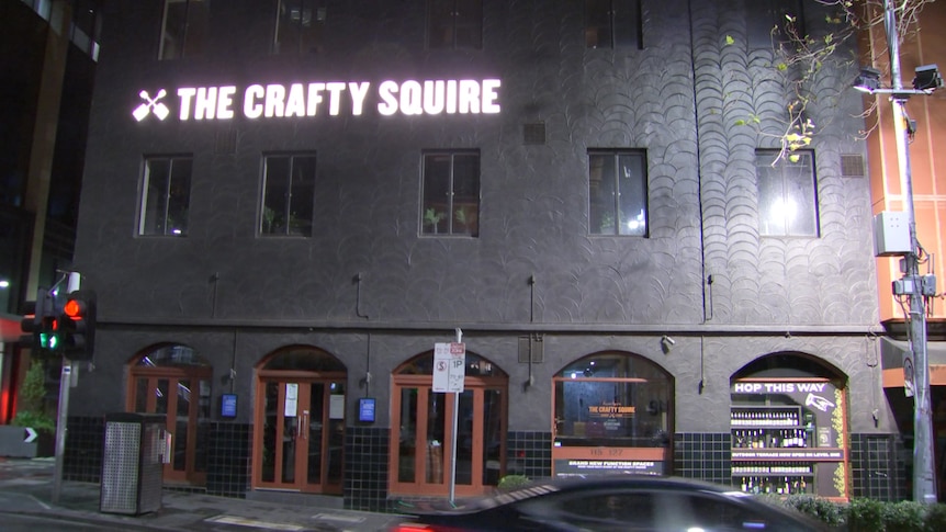 The Crafty Squire sign outside the pub at night.