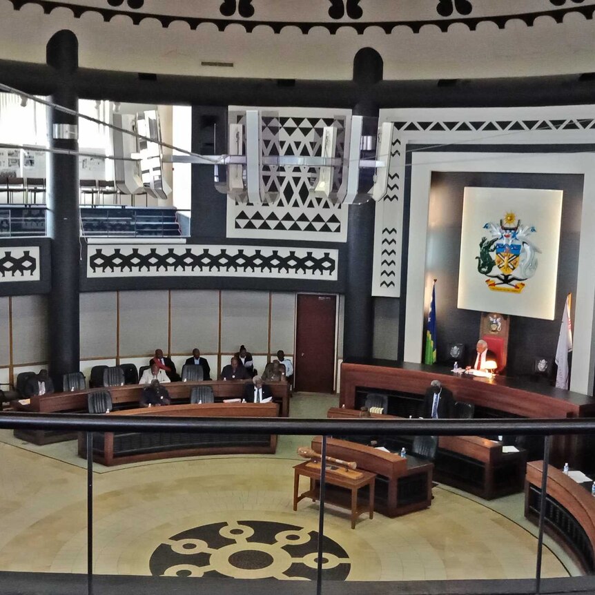 A wide shot inside the chambers of the national parliament of Solomon Islands.