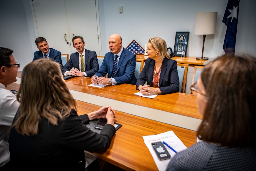 Peter Dutton and other senior members of the Coalition sit around a meeting table