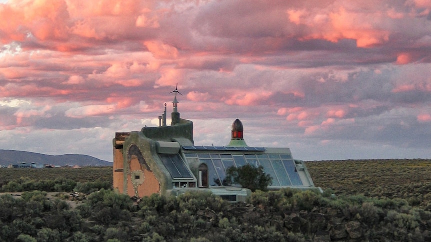 Built in 1996 the Nautilus Earthship in New Mexico was built on lava rock site with full-height tyre walls.