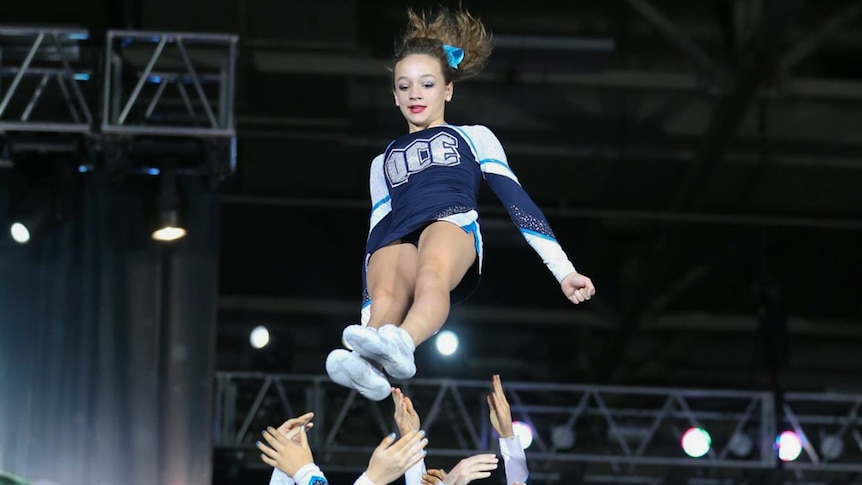 Team members tumble, throw and jump through routines that are scored by judges.