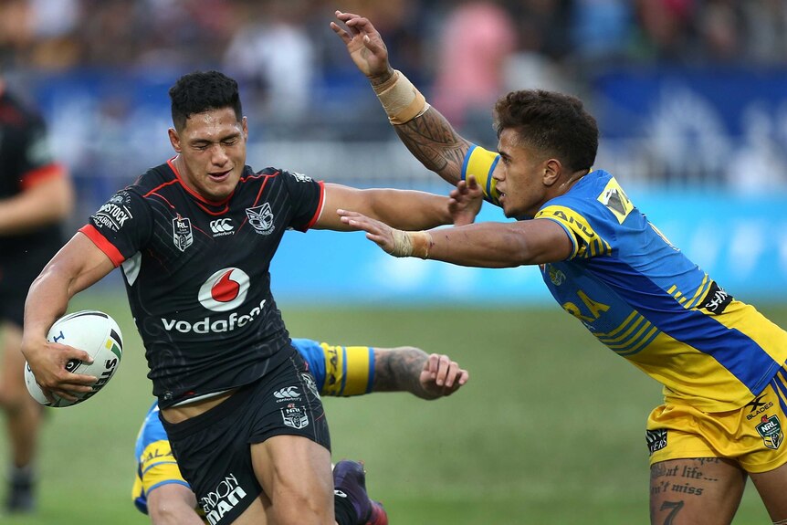 Captain Roger Tuivasa-Sheck of the Warriors is challenged by Kaysa Pritchard of the Eels