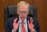 Commissioner Kenneth Hayne with hands outstretched at the banking and financial services royal commission
