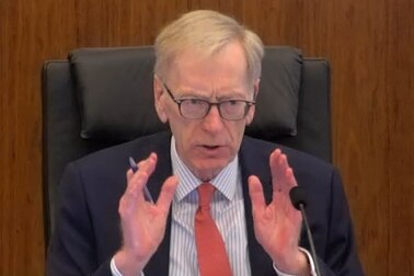 Commissioner Kenneth Hayne with hands outstretched at the banking and financial services royal commission