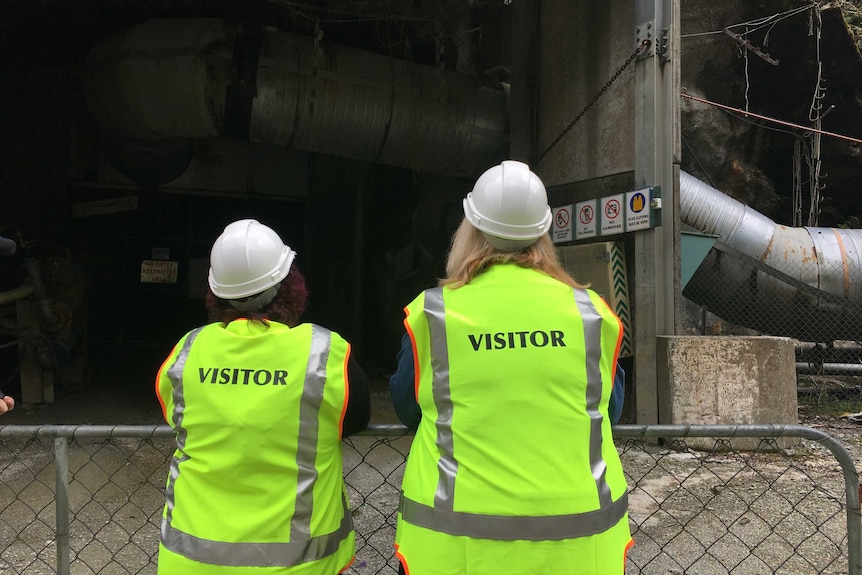 Anna Osborne and her friend Sonya Rockhouse stand outside the mine's burnt entrance.