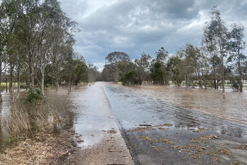 A country road covered in floodwater.
