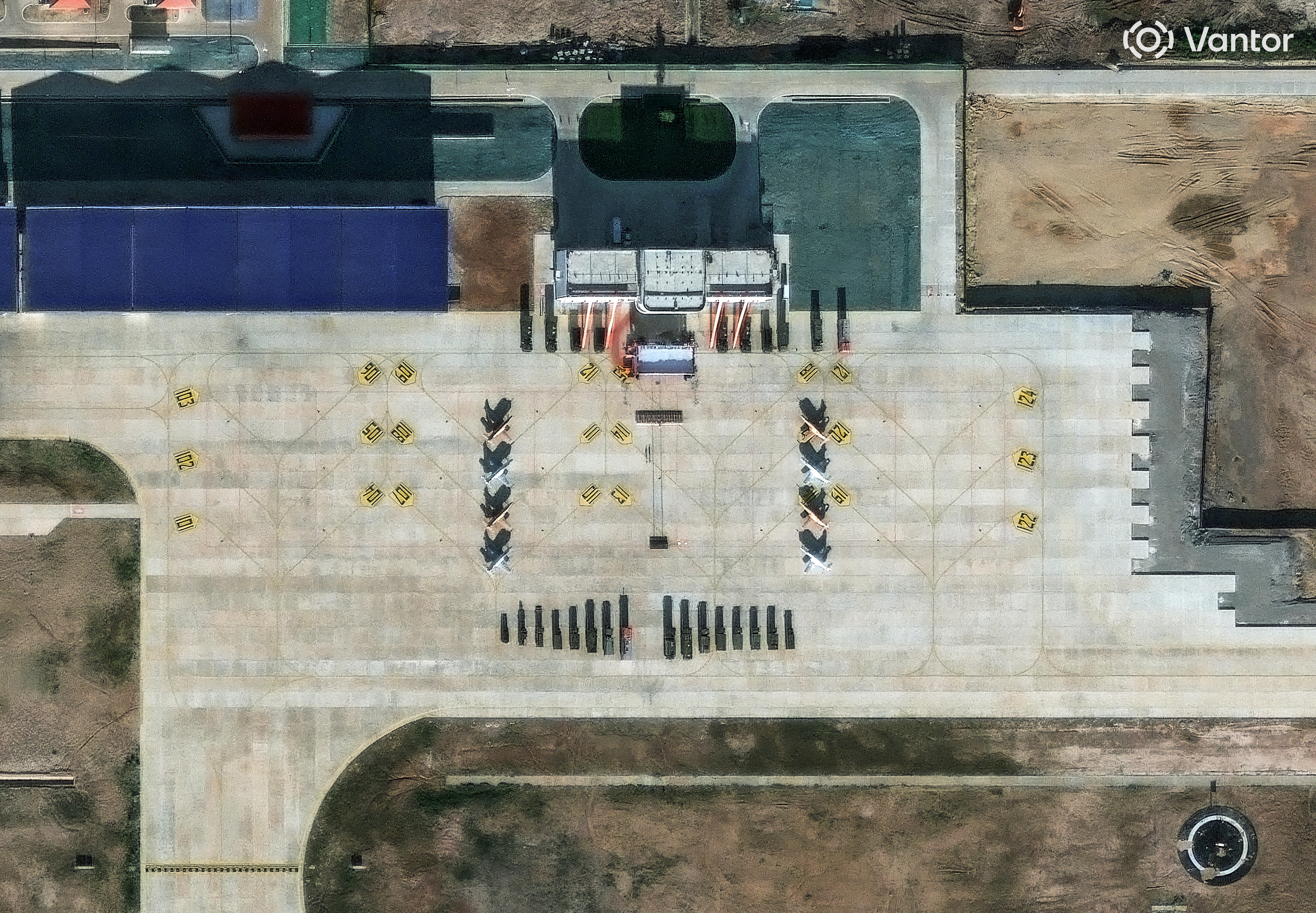 A satellite image shows what security analysts believe are Y-8 light attack fighters and support vehicles at an air base.