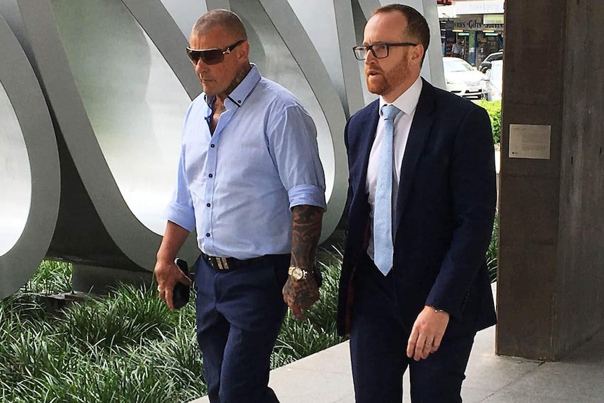 Allan McQueen (L) arriving to court in Brisbane