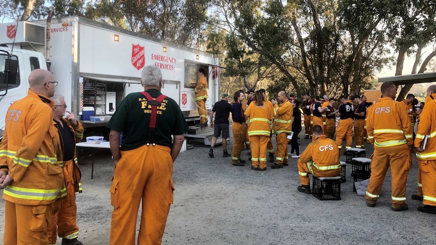 CFS firefighters gather outside a Salvation Army truck.