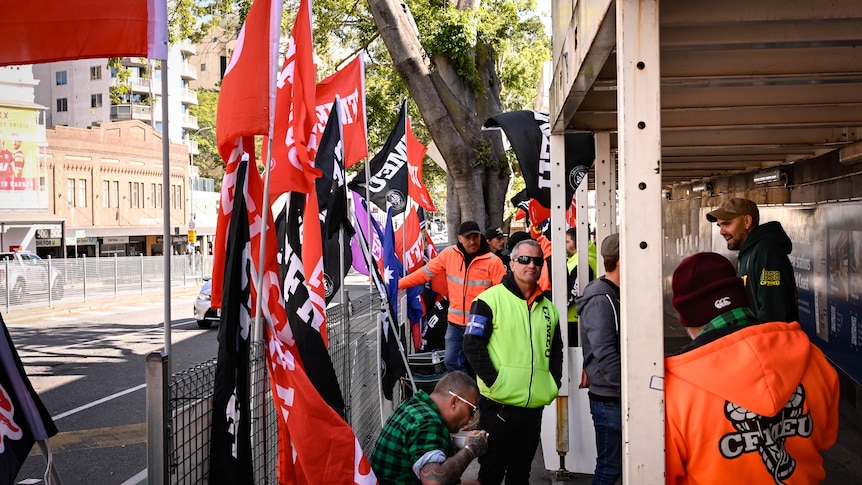 Union members protest next to a road