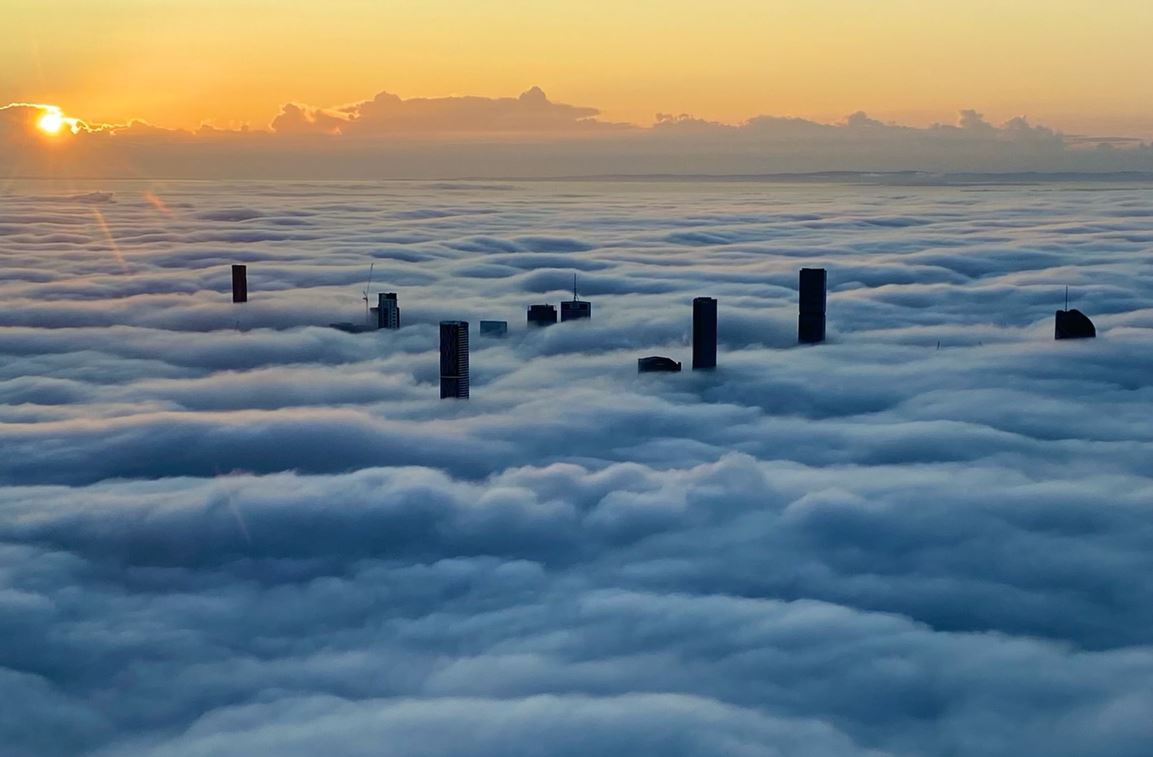 Aerial view of Brisbane CBD covered in fog.