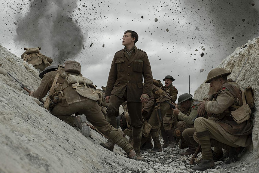 Actor George McKay stands in a trench in a still from the World War I drama 1917