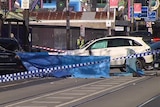 A white Mercedes is roped off by police tape after a fatal hit-and-run on Chapel Street.