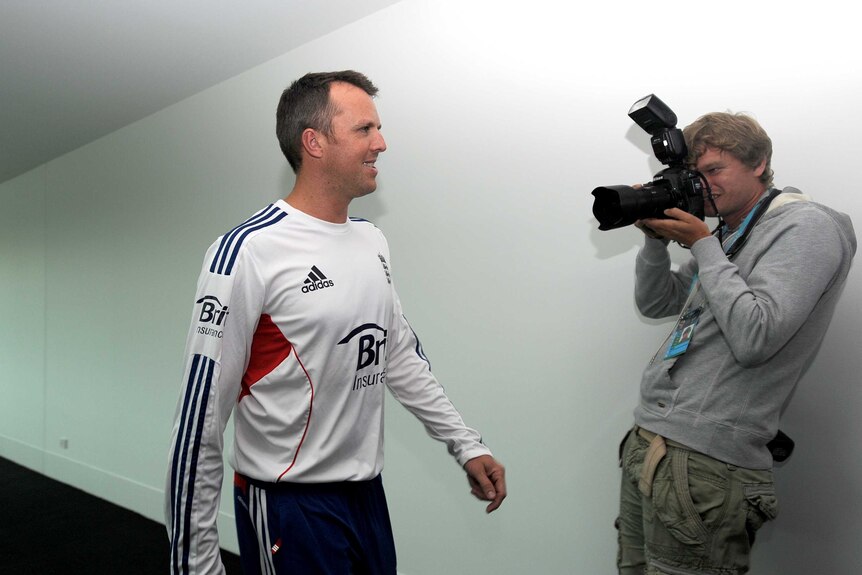 England's Graeme Swann goes to a media conference to announce his retirement.