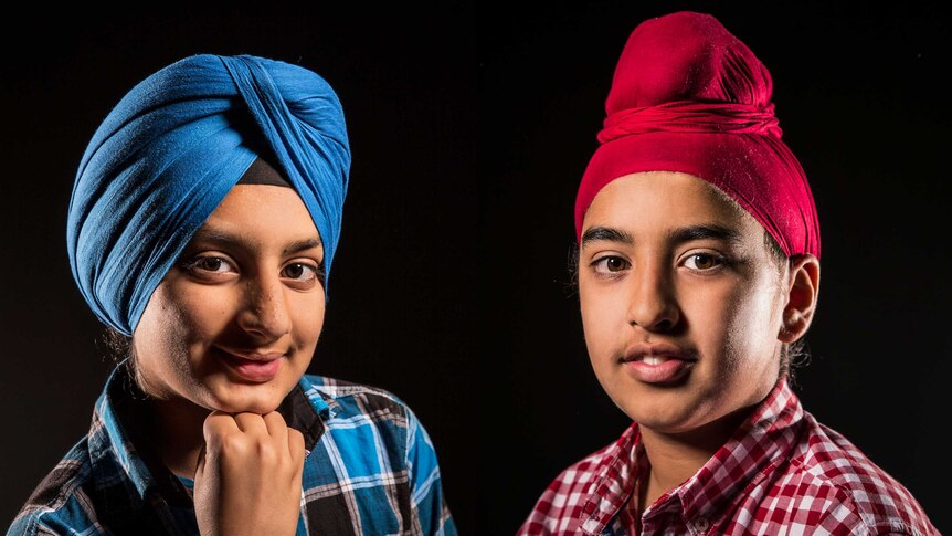Two young Sikh boys wear turbans. Prabhjot Singh wears a blue dastaar style and Jasjaap Singh wears a red 'L-plate' version.