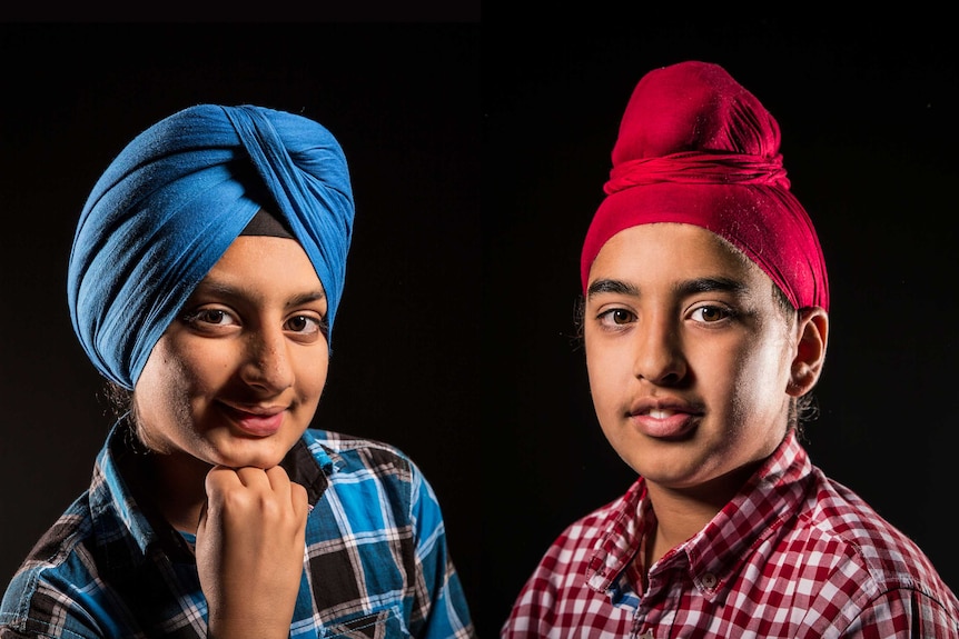 Two young Sikh boys wear turbans. Prabhjot Singh wears a blue dastaar style and Jasjaap Singh wears a red 'L-plate' version.