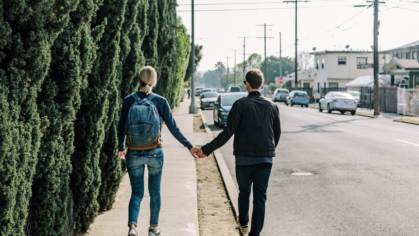 Young couple holding hands.