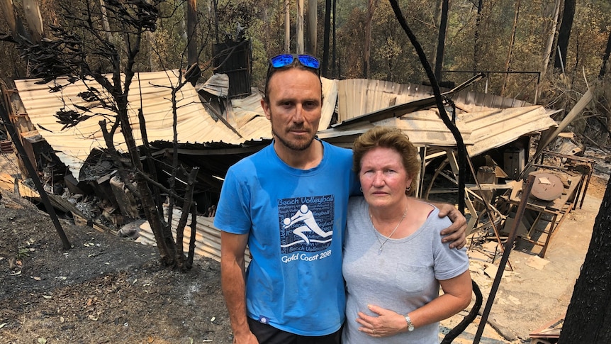 Ben and Nita Ford stand in front of the shed that was destroyed during the Lower Beechmont bushfire