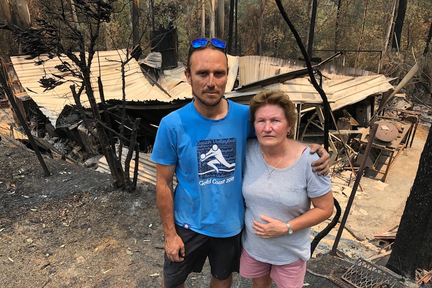 Ben and Nita Ford stand in front of the shed that was destroyed during the Lower Beechmont bushfire