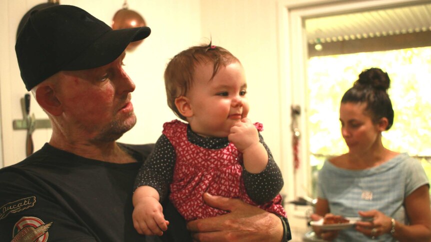 Matt Golinski and his fiancee Erin Yarwood prepare a meal in their Pomona home kitchen with their daughter Aluna.