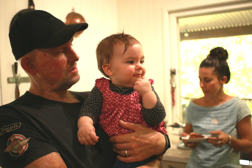 Matt Golinski and his fiancee Erin Yarwood prepare a meal in their Pomona home kitchen with their daughter Aluna.