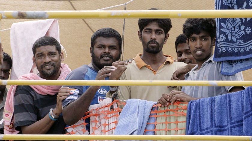 Four Sri Lankan asylum seekers look out from the Oceanic Viking.