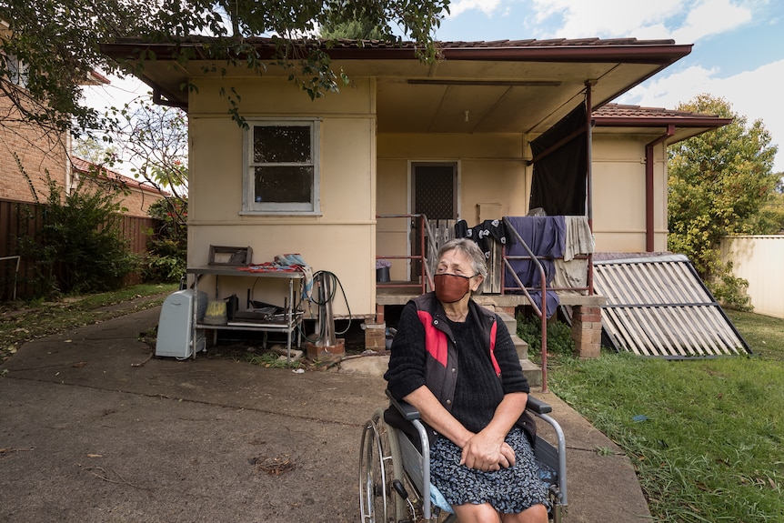 a woman is sitting in a wheelchair and looking to the left