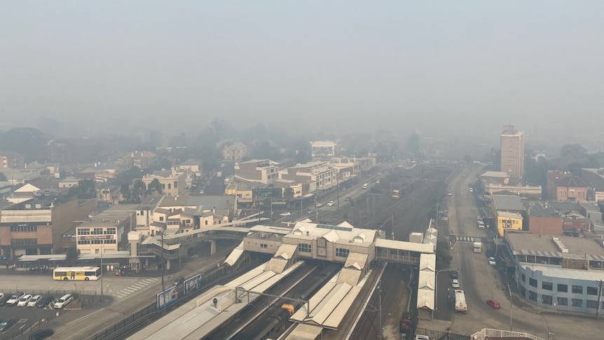 Thick smoke blankets the railway station at Granville, in western Sydney.