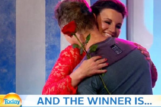 Jacqui gives a man a rose on TV