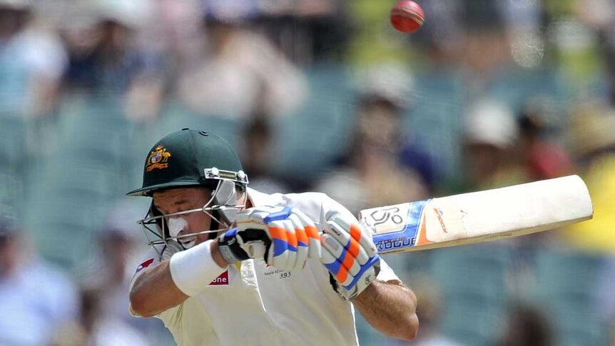 Grinding away... Mike Hussey fends off a short-pitched delivery.