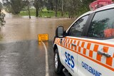 A flooded road and SES vehicle