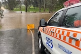 A flooded road and SES vehicle