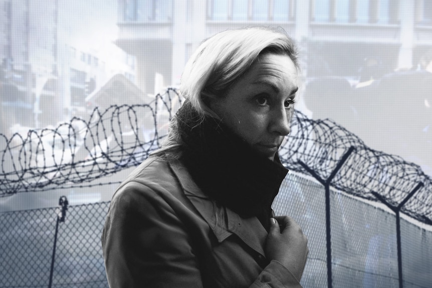 A graphic of keli Lane wearing a jacket with barbed wires behind her and a building